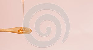 close up honey pouring spoon