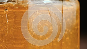 Close up of honey stick in jar