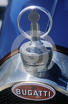 A close-up of a hood ornament on a vintage Bugatti automobile at the Laguna Seca Classic Car Show in Carmel, CA