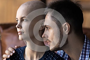 Close up hopeful sick hairless woman and man visualizing future