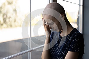 Close up hopeless unhappy sick hairless woman lost in thoughts