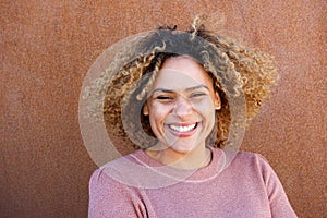 Close up horizontal beautiful african american woman smiling against brown background