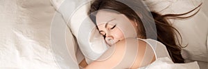 Above panoramic view young woman sleeping in bed hugging pillow