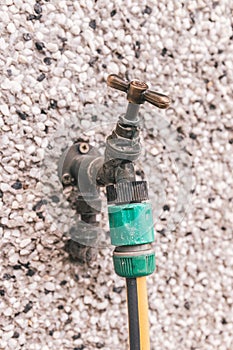 Close up of a hose pipe connected to a water valve