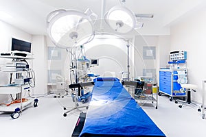 Close up hospital interior. Operating room with surgery lamps and medical equipment photo