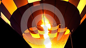 Close up of hot air balloon burner flame glowing at night