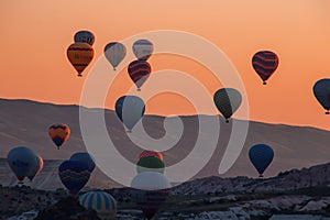 Close up of hot air balloons flying over Cappadocia Turkey at sunrise golden hour