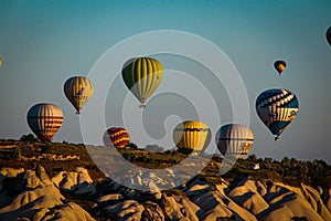 Close up of hot air balloons flying over Cappadocia Turkey at sunrise golden hour