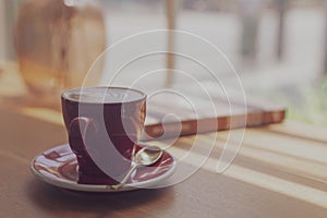 Close up hot art Latte, cappuccino Coffee in red cup on wooden table in Coffee shop blur background with bokeh image process with