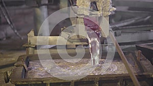 Close-up, the hot metal is drained from the furnace. Creek molten aluminum. Metallurgical industry