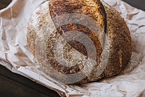 Close-up hot rye circle bread with crispy crust on a craft package