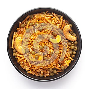 Close-Up of Hot spicy Kashmiri Mixture Namkeen snacks in a black ceramic bowl made with dry fruits, peanuts,.