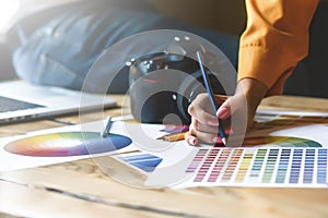 Close up hoto of Interior designers teamwork with house building plans on office desk, architects working with many-color palette