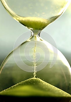 Close up hourglass counting down time with sand view