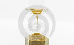 Close up Hourglass with golden sand, on white background