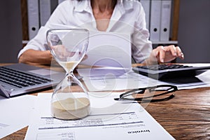 Close-up Of A Hourglass On Invoice