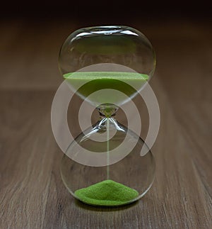 Close-up, hourglass on a wooden blurred background