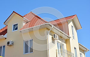 Close up on house attic roof guttering pipeline system problem area. Installing and repair roof gutter