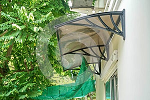 close up house awning and sunshade with star gooseberry tree in home garden