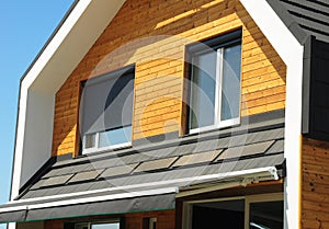 Close up on House Blinds Sun Protection Exterior. Windows in New Modern Passive House Facade Wooden Wall with Shutters Closed and