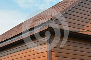 A close-up of a house corner with exterior wood siding panels, timber cladding walls with a metal roof construction without a roof