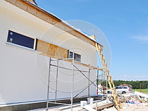 Close up on house garage wall with unfinished fascia boards installation outdoors. Fascias and Soffits house roof installation