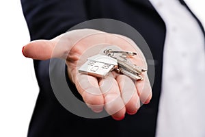 Close-up of house keys held in palm by real-estate agent woman