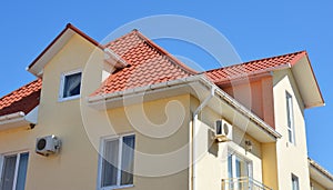 Close up on house rooftop with plastic rain gutter pipeline, soffit and fascia boards. Guttering attic house in problem areas