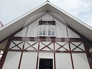 Close up a house with white glass windows and brown wall ornaments