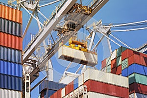 Close-up of how containers are being discharged from a large container ship by a crane