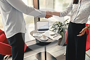 Close up of HR manager shaking hands with a successful job candidate during an interview