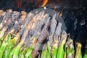 Close-up of huge bunch of traditional catalan calsots prepared on fire photo