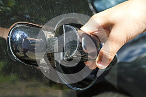 Close up of human child hand opening car door