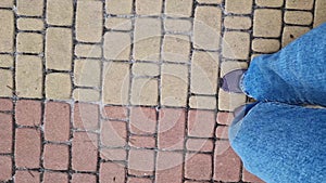 Close-up of human feet walking down the street. Hiking