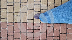 Close-up of human feet walking down the street. Hiking