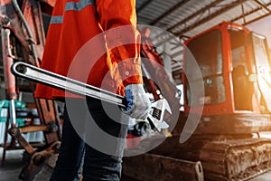 Close up of a human hand holding a tool for maintenance or excavator at maintenance center, Heavy Duty Equipment Maintenance.