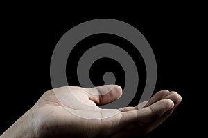 Close-up human hand on isolate black background.