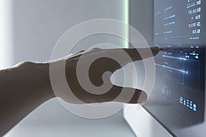 Human hand interacting with futuristic digital touchscreen interface technology innovation and data visualization concept