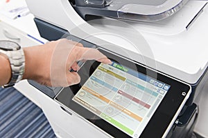 Human hand is using the printer