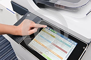 Human hand is using the printer