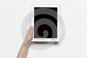Close up of human hand using tablet with blank black screen, education and business concept
