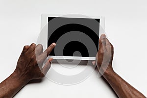 Close up of human hand using tablet with blank black screen, education and business concept