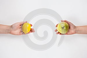 Close up of human hands exchanging different products isolated on white. Food sharing between people. Give a friend healthy fruits