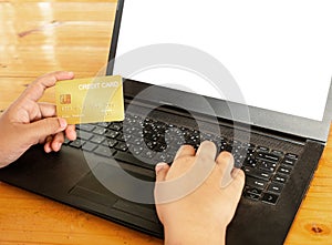 Close-up human hands holding a credit card and using computer. o