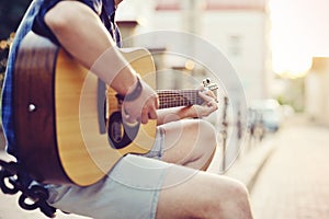 Close up of human hands playin guitar