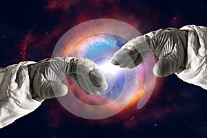 Close up of human hands touching with fingers in space. Nebula on background. Elements of this image furnished by NASA