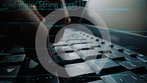 Close-Up of Human Hands Typing on Computer Keyboard with Programming Code and Digital Data in Background for Technology