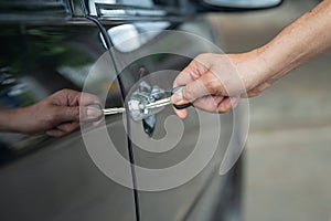 Close up of human male hand opening car door.