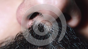 Close-up of a human male nose and black moustaches. Human`s face.