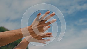 Close-up human moving hands as if controlling power of air and nature. Strange dance hand of male person on sea coast